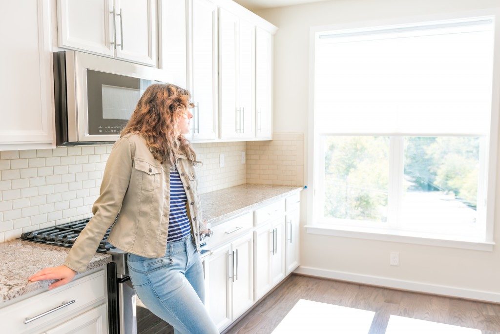 woman standing in a new kitchen