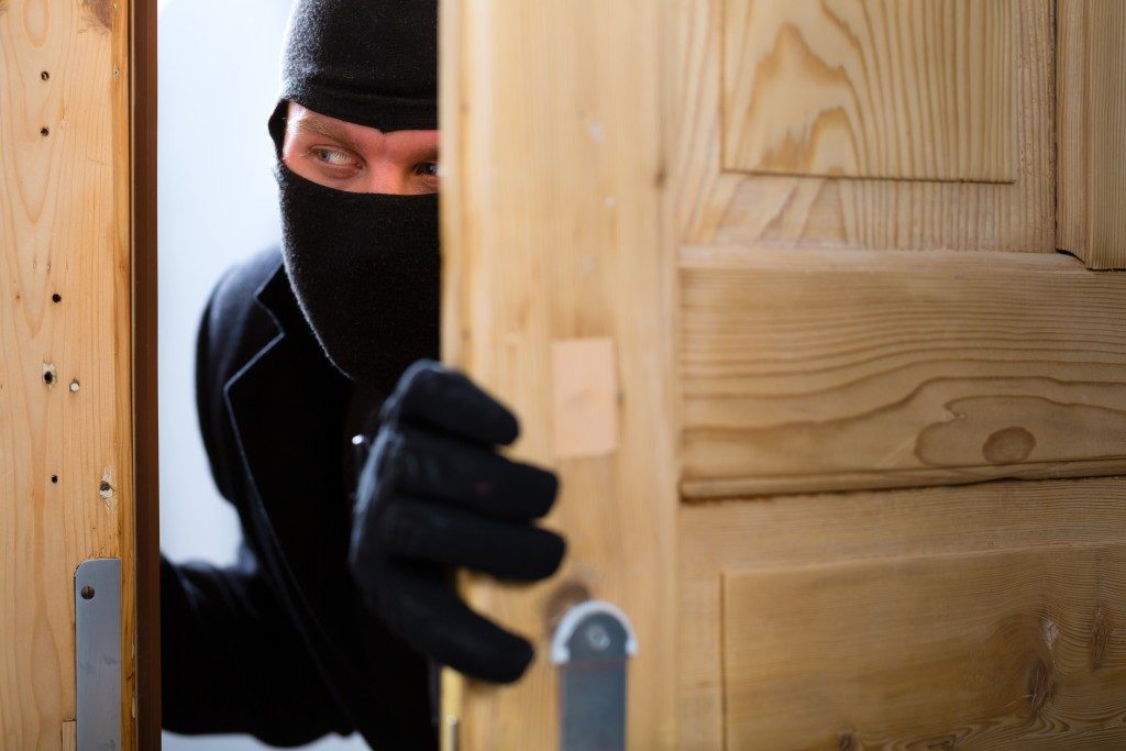 disguised burglar breaking in 