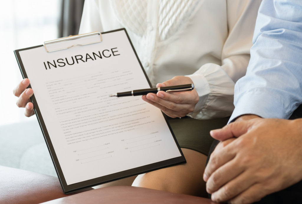 pointing to an insurance policy for signature