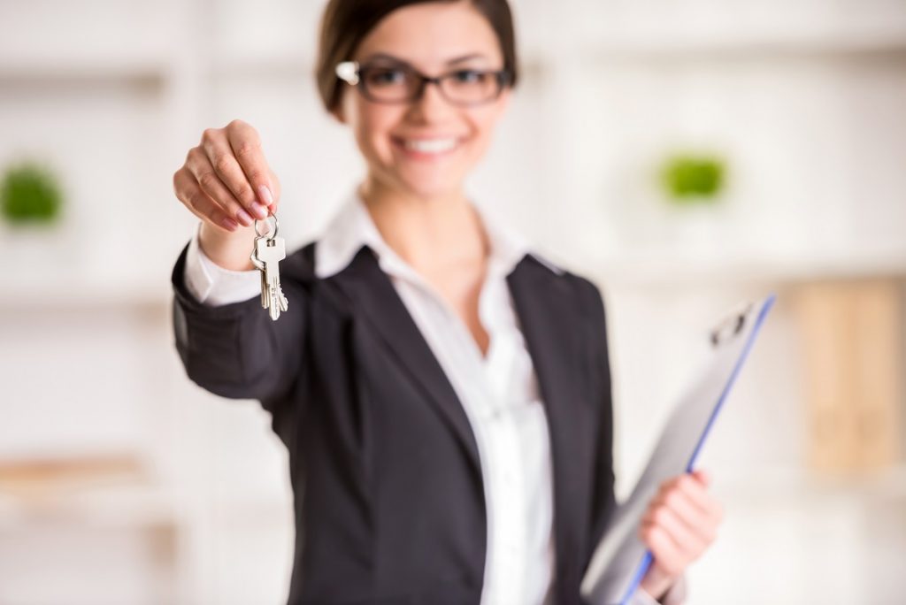 woman handing house key