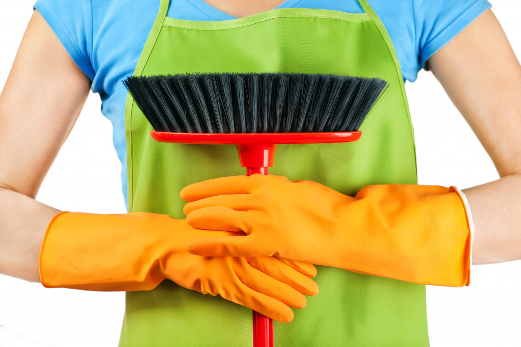 a woman holding materials needed for deep cleaning